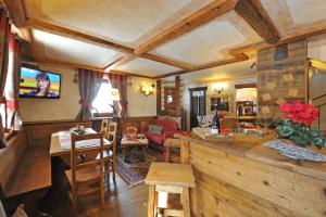 a kitchen and living room with a couch and a table at Affittacamere Petit Coeur in Champoluc