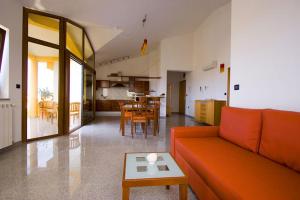 a living room with an orange couch and a table at Apartments Ana Wellness S in Rovinj
