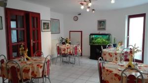 a dining room with tables and a fish tank at Ria Panzio in Esztergom
