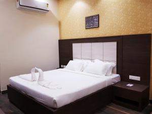 a bedroom with a bed with white towels on it at Hotel Starway in Balasore