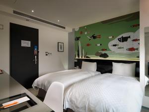 Postel nebo postele na pokoji v ubytování CityInn Hotel Plus - Taichung Station Branch + 37 fotografií