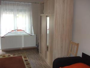 a living room with a window and a chair at Anikó Apartman in Siófok
