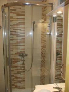 a bathroom with a shower with a sink and a toilet at Anikó Apartman in Siófok +10 photos