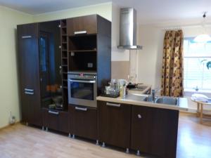 a kitchen with a sink and a stove top oven at Viva Apartment in Tallinn