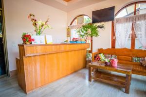 a lobby with a counter and a bench and a table at Happy in Pai in Pai