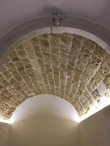 a stone ceiling in a room with a light at B&B Macrina in Noto
