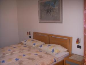 a bedroom with a bed and a picture on the wall at Apartments Ana Wellness L in Rovinj