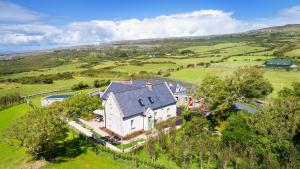 an aerial view of a large white house in a field at The Hawthorn in Doolin