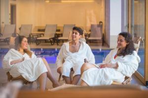 a group of people in white robes sitting at Bio Agritur Le Millemele in Spormaggiore