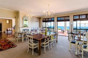 a dining room with a table and chairs at Whale View Manor & Spa in Simonʼs Town