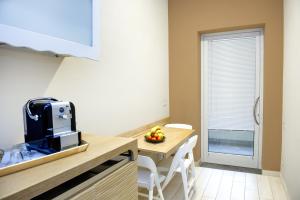 a kitchen with a table with a bowl of fruit on it at Hotel C'era Una Volta in Castiglione della Pescaia