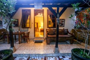 a living room with a couch and a table at Gusti Kaler House in Ubud