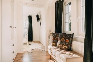a living room with a couch and a window at Harz Cottage Emma in Bad Lauterberg +16 photos