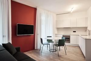 a kitchen and a living room with a table and chairs at La Perla by Sedar in Como