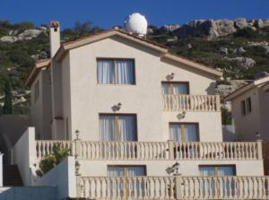 a large white building with a white ball on the roof at Villa Aphrodite in Peyia