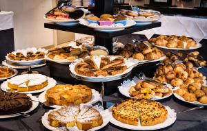 a display of different types of pies and pastries at Grand Hotel Resort&SPA Ma&Ma - Adults Only in La Maddalena +162 photos
