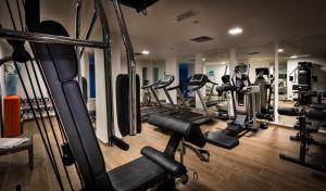 a gym with lots of treadmills and machines at Grand Hotel Resort&SPA Ma&Ma - Adults Only in La Maddalena