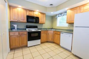 a kitchen with wooden cabinets and white appliances at General Butler State Resort Park in Carrollton