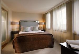 a hotel room with a large bed and a window at The Bristol Hotel in Bristol