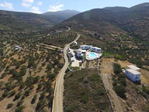 an aerial view of a house on a hill with a road at Amorgion Village in Katapola