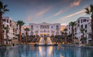 a rendering of the exterior of a resort with palm trees at Four Seasons Hotel Tunis in Gammarth