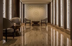 a lobby with chairs and a table and a wall at Four Seasons Hotel Tunis in Gammarth