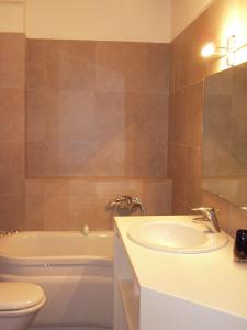 a bathroom with a sink and a toilet and a tub at Sassetta Holiday in Sassetta