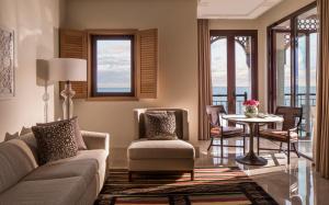 a living room with a couch and a table at Four Seasons Hotel Tunis in Gammarth