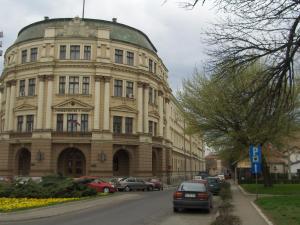 a large building with a green dome on a street at Mps Lux Apartments in Niš