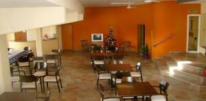 a dining room with tables and chairs and a christmas tree at Hotel Playa in Villa Carlos Paz