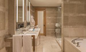 a bathroom with two sinks and a shower at Four Seasons Hotel Tunis in Gammarth