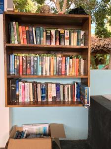 a book shelf filled with lots of books at Arne's Place in Arugam Bay