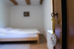 a wooden door with a key in a room with a bed at Vila Viktorija in Brod na Kupi