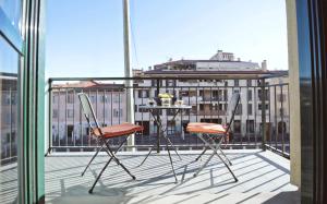 un tavolo e 2 sedie seduti su un balcone di Orea Spiti - Charming Flat & Canal View Few steps from Movida a Milano