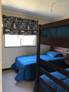 a bedroom with two bunk beds and a window at Casa Los Robles in Pucón