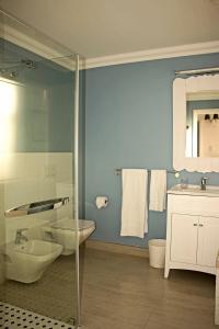 a bathroom with a toilet and a sink and a shower at Casa al Mare Guest House in Swakopmund