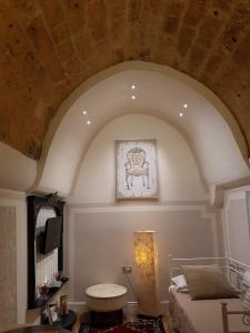 レッチェにあるFjore Di Lecceのアーチ型のベッドルーム(ベッド1台、テレビ付)