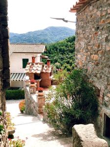 a stone building with a view of a mountain at Mini Appartamenti Nonna Nella in Barbarasco