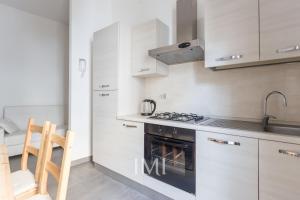 a small kitchen with a stove and a sink at Milan Center Apartment in Milan