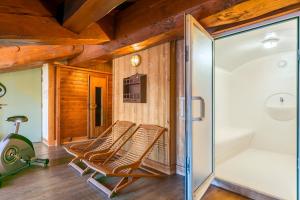a room with two chairs and a sliding glass door at Hotel Kandahar in Val-d'Isère