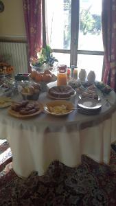 uma mesa branca com comida e velas em Villa Carmen on Etna em Trecastagni