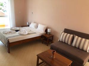 a bedroom with a bed and a couch at Green Turaco in Zanzibar City