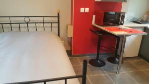 a bedroom with a bed and a desk with a computer at Les Mouettes 2 in Le Tréport