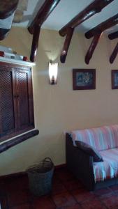 a living room with a couch and a window at El Nido in Zahara de la Sierra