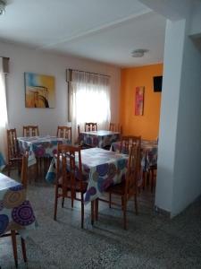 un comedor con mesas y sillas y una ventana en Hotel San Antonio en San Bernardo