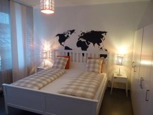 a bedroom with a bed with a world mural on the wall at The modern apartment in Prague