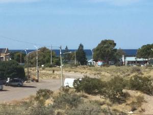 een parkeerplaats met auto's geparkeerd in een veld bij Wind Puerto Madryn in Puerto Madryn