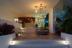 a lobby of a building with stairs and a chandelier at Anah Suites in Playa del Carmen