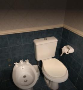 uma casa de banho com um WC branco e um lavatório. em Alcor Hotel em Mendoza