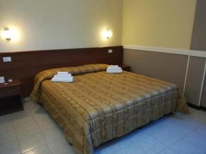 a bedroom with a bed with two towels on it at Hotel Marco Polo SELF CHECK-IN in Bologna